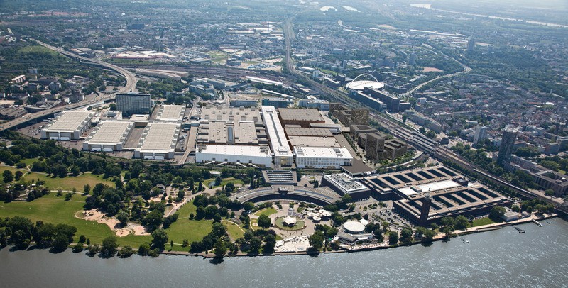 Vue aérienne du Rheinpark avec le Hall 1 (à gauche), Confex (à droite) et le projet de terminal Est-Ouest à Cologne.